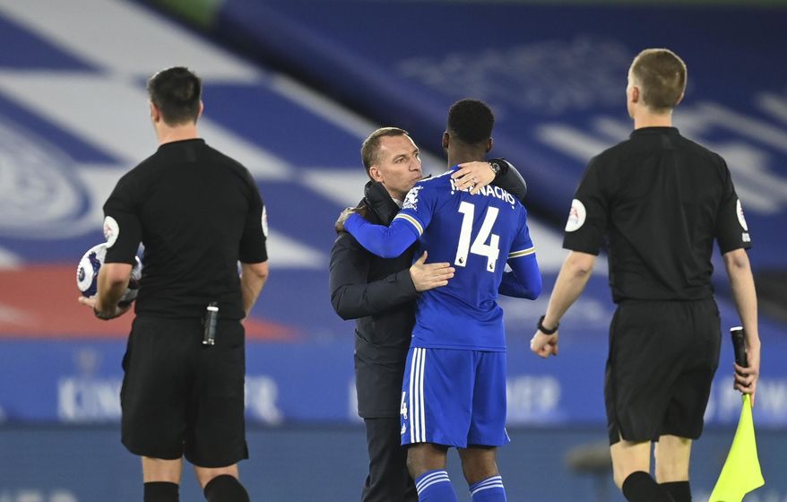 Leicester&#x27;s manager Brendan Rodgers, second left, celebrates with Leicester&#x27;s Kelechi Iheanacho at the end of the English Premier League soccer match between Leicester City and West Bromwich Albion at the King Power Stadium in Leicester, England, Thursday, April 22, 2021. (Michael Regan/Pool via AP)