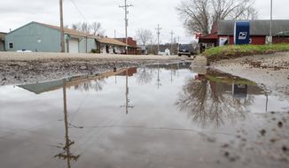 Water after a rainstorm pools the streets in Paxico, Kansas, on March 24, 2021.  “We have terrible stormwater runoff,” said resident Deanna Pierson. “We’re in a flood zone.” (Evert Nelson/The Topeka Capital-Journal via AP)