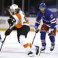 Philadelphia Flyers&#39; Jakub Voracek (93) takes the puck as New York Rangers&#39; Kevin Rooney (17) defends in the first period of an NHL hockey game Thursday, April 22, 2021, in New York. (Elsa/Pool Photo via AP)