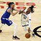 Memphis Grizzlies guard Ja Morant (12) is defended by Los Angeles Clippers guard Amir Coffey during the first half of an NBA basketball game Wednesday, April 21, 2021, in Los Angeles. (AP Photo/Marcio Jose Sanchez)