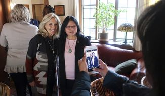 FILE - In this May 22, 2019, file photo, Jill Biden, left, and Tuba City Regional Health Care Corp. CEO Lynette Bonar pose for photos after an event in Flagstaff, Ariz. Biden is traveling to the country&#39;s largest Native American reservation, the Navajo Nation, which was hit hard by the coronavirus but is outpacing the U.S. in vaccination rates while maintaining strict pandemic restrictions. The trip, scheduled for Thursday and Friday, April 22-23, 2021, will be Biden&#39;s third to the reservation that spans 27,000 square miles (70,000 square kilometers) in the Four Corners region, and her inaugural visit as first lady. (AP Photo/Felicia Fonseca, File)