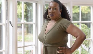 Tarana Burke, founder and leader of the #MeToo movement, stands in her home in Baltimore on Oct. 13, 2020. Black women and girls are now the focus of several high-profile philanthropic initiatives as major donors look to address the racial wealth gap and the long-chronicled funding disparity for organizations serving minority women. Teresa Younger, who helped launch The Black Girl Freedom Fund and its 1Billion4BlackGirls campaign in September with other Black women in philanthropy and activism — including Me Too Founder Tarana Burke — said that donors should be cautious about making assumptions in their giving. (AP Photo/Steve Ruark, file)