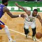 Boston Celtics guard Kemba Walker (8) drives against Phoenix Suns center Deandre Ayton (22) during the second half of an NBA basketball game Thursday, April 22, 2021, in Boston. (AP Photo/Elise Amendola)