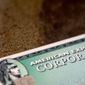 This Aug. 11, 2019, file photo shows an American Express card in New Orleans. (AP Photo/Jenny Kane, File)