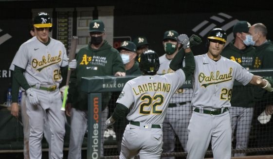 Oakland Athletics&#39; Ramon Laureano (22) celebrates with Matt Olson after hitting a solo home run during the fifth inning of the team&#39;s baseball game against the Baltimore Orioles, Friday, April. 23, 2021, in Baltimore. (AP Photo/Tommy Gilligan)