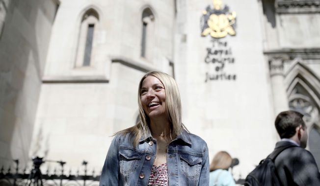 Emma Jones, the daughter of now deceased postmaster Julian Wilson, outside the Royal Courts of Justice, London, after her father&#x27;s conviction was overturned by the Court of Appeal, Friday, April 23, 2021. A British appeals court has overturned the convictions of 39 postmasters and postmistresses who were accused of theft, fraud and false accounting following the installation of a new computer system in local branches. Announcing the Court of Appeal ruling on Friday, a judge said Britain’s postal service “knew there were serious issues about the reliability” of the Horizon computer system and had a “clear duty to investigate” its defects. (Yui Mok/PA via AP)