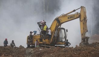 Gold miners on a bulldozer try to put out a fire set by the National Police at an illegal mining operation as part of the Armed Forces&#39; &amp;quot;Operation Guamuez III&amp;quot; in Magui Payan, Colombia, Tuesday, April 20, 2021. None of the workers were detained during the destruction of machinery, but in previous days some machinists and material suppliers were detained, according to Army Col. Pedro Pablo Astaiza. (AP Photo/Fernando Vergara)