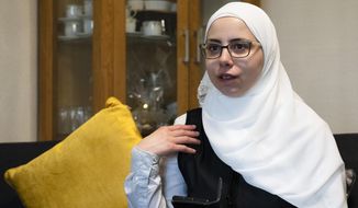 Faeza Satouf, a Syrian refugee who was granted asylum in Denmark in 2015, talks to The Associated Press during an interview in Nivaa, Denmark, Wednesday, April 21, 2021. Ten years after the start of the Syrian civil war, Denmark has become the first European country to start revoking the residency permits of some refugees from the Damascus area, including Satouf&#39;s. (AP Photo/David Keyton)