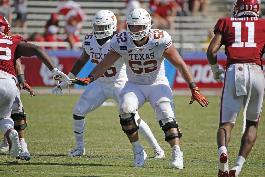FILE - Texas offensive lineman Samuel Cosmi (52) prepares to block against Oklahoma during the second half of an NCAA college football game in Dallas, Texas, in this Saturday, Oct. 10, 2020, file photo. The Kansas City Chiefs already have spent the offseason rebuilding an offensive line ravaged by injuries and then dominated by Tampa Bay in the Super Bowl. But there is still work to be done, and the next opportunity to provide some help up front for quarterback Patrick Mahomes is the NFL draft. (AP Photo/Michael Ainsworth, File)
