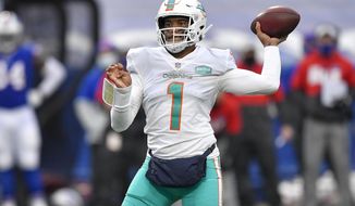 FILE - In this Jan. 3, 2021, file photo, Miami Dolphins quarterback Tua Tagovailoa (1) throws a pass during the second half of an NFL football game against the Buffalo Bills in Orchard Park, N.Y. The Dolphins have already been busy in the draft, even though it has not started yet. They have made three trades involving their top selection, moves motivated by Miami&#39;s desire to stockpile picks without giving up the chance to acquire a playmaking target for Tagovailoa. (AP Photo/Adrian Kraus, File)
