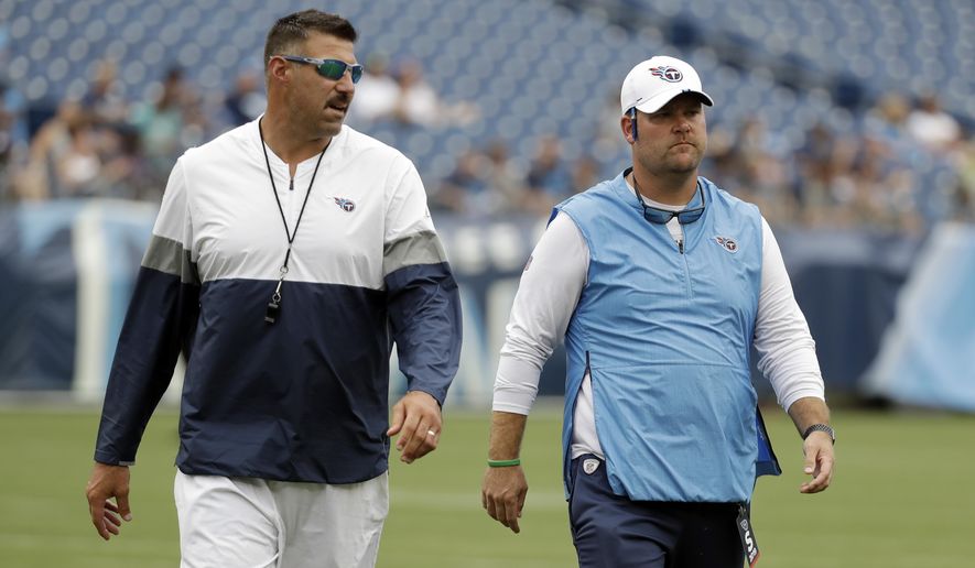 FILE — In this Aug. 3, 2019, file photo, Tennessee Titans head coach Mike Vrabel, left, and general manager Jon Robinson walk on the field before a practice during NFL football training camp in Nashville, Tenn. The Titans have been picking themselves apart since the season ended. They won the AFC South and hosted a playoff game for the first time since 2008, but they lost on their own field, well short of the AFC championship game of a year before. (AP Photo/Mark Humphrey, File)