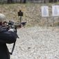 A shooter fires a rifle at a target at Slate Ridge Vermont, an unpermitted gun range and firearms training center, Saturday April 17, 2021 in West Pawlet, Vt., during what organizers called a Second Amendment Day Picnic. A judge has ordered the owner of Slate Ridge to survey the property and demolish any unpermitted structures. (AP Photo/Wilson Ring)