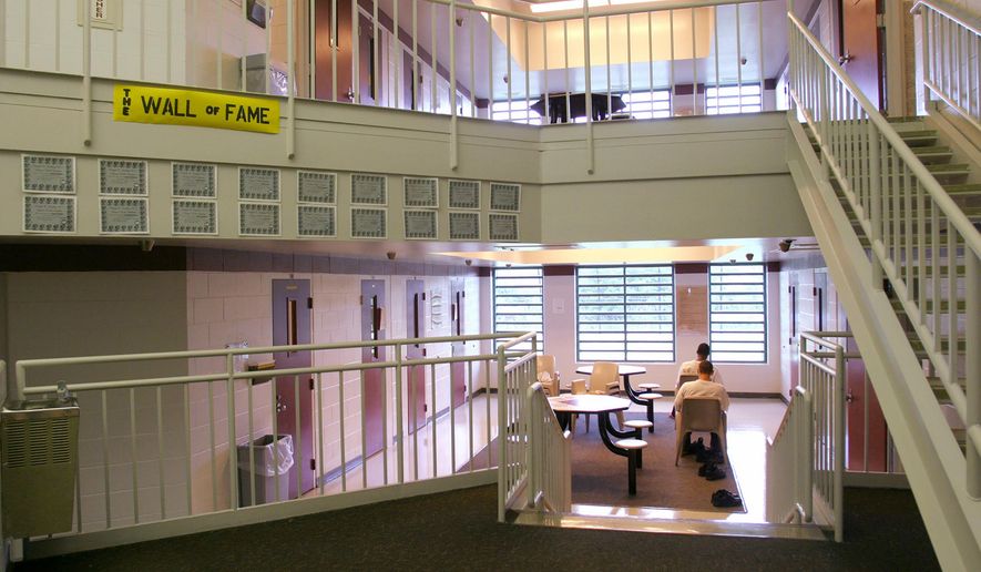 FILE - In this May 18, 2004 file photo inmates sit in one of the cottages at the Circleville Juvenile Correctional Facility in Circleville, Ohio. A coroners report released Thursday, March 18, 2021, indicates Robert Wright, 17, who was found dead last year at the Ohio juvenile detention facility suffered from heart disease and also had "amphetamine intoxication" at the time of his death. Wright was found dead by a guard who entered his cell to tell him it was time to take medication, said a report by the Ohio State Highway patrol that includes coroner's findings. (Tim Revell/The Columbus Dispatch via AP, File)