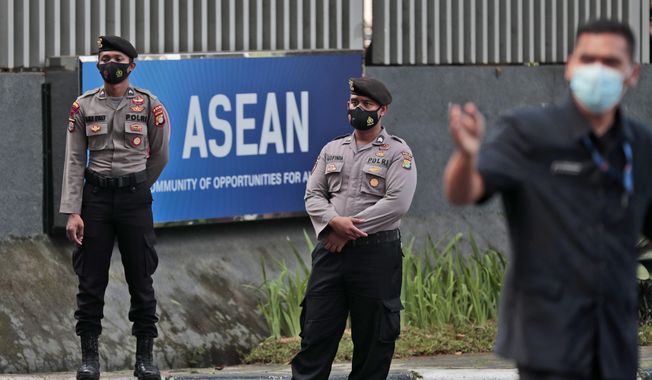 Police officers stand guard outside the Association of Southeast Asian Nations (ASEAN) Secretariat ahead of a leaders&#x27; meeting in Jakarta, Indonesia, Friday, April 23, 2021. The 10-member Association of Southeast Asian Nations is scheduled to hold a special summit to discuss Myanmar on Saturday. (AP Photo/Dita Alangkara)