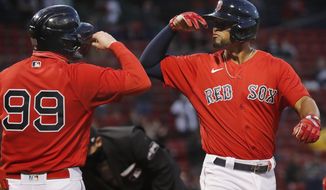 Boston Red Sox&#39;s Xander Bogaerts celebrates his two-run home run that also drove in Alex Verdugo (99) during the first inning of a baseball game against the Seattle Mariners, Friday, April 23, 2021, in Boston. (AP Photo/Michael Dwyer)