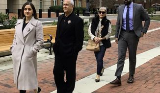 FILE - From left, Negeen Ghaisar, James Ghaisar, Kelly Ghaisar and Kouros Emami, family of Bijan Ghaisar walk outside federal court in Alexandria, Va., on Friday, March 6, 2020. A federal judge is set to hear arguments on whether Virginia prosecutors can bring manslaughter charges against two U.S. Park Police officers accused of fatally shooting unarmed motorist Bijan Ghaisar, in 2017. A hearing is scheduled Friday, April 23, 2021, in Alexandria. (AP Photo/Matthew Barakat, File)
