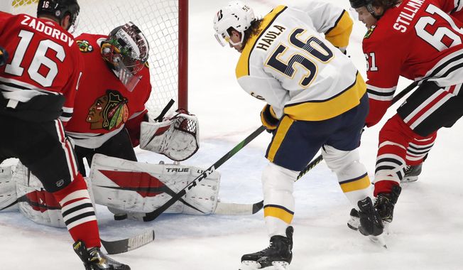 Nashville Predators left wing Erik Haula (56) tries to get the puck past Chicago Blackhawks goaltender Malcolm Subban (30) as Blackhawks&#x27; Nikita Zadorov (16) and Riley Stillman (61) defend during the second period of an NHL hockey game Friday, April 23, 2021, in Chicago. (AP Photo/Jeff Haynes)