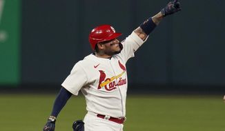 St. Louis Cardinals&#39; Yadier Molina celebrates after hitting an RBI double during the third inning of a baseball game against the Cincinnati Reds Friday, April 23, 2021, in St. Louis. (AP Photo/Jeff Roberson)