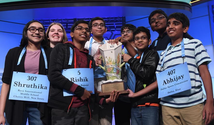 FILE - In this Friday, May 31, 2019 file photo,T he eight co-champions of the 2019 Scripps National Spelling Bee, from left, Shruthika Padhy, 13, of Cherry Hill, N.J., Erin Howard, 14, of Huntsville, Ala., Rishik Gandhasri, 13, of San Jose, Calif., Christopher Serrao, 13, of Whitehouse Station, N.J., Saketh Sundar, 13, of Clarksville, Md., Sohum Sukhatankar, 13, of Dallas, Texas, Rohan Raja, 13, of Irving, Texas, and Abhijay Kodali, 12, of Flower Mound, Texas, hold the trophy at the end of the competition in Oxon Hill, Md. The Scripps National Spelling Bee is undergoing a major overhaul to ensure it can identify a single champion, adding vocabulary questions and a lightning-round tiebreaker to this year's pandemic-altered competition, Friday, April 23, 2021. (AP Photo/Susan Walsh, File)
