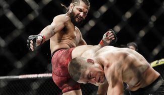 FILE - Jorge Masvidal, left, kicks Nate Diaz during the first round of a welterweight mixed martial arts bout at UFC 244 in New York, in this early Sunday, Nov. 3, 2019, file photo. UFC 261 is being touted as the first full-capacity sporting event held indoors in more than a year. The card features three title fights, highlighted by a rematch between reigning welterweight champion Kamaru “Nigerian Nightmare” Usman (18-1) and Jorge “King of Miami” Masvidal (35-14). (AP Photo/Frank Franklin II, File)