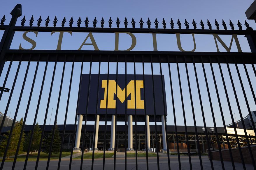 FILE - In this Aug. 14, 2020 file photo, The University of Michigan football stadium is shown in Ann Arbor, Mich. The University of Michigan will require COVID-19 vaccinations for students who live on its Ann Arbor campus this fall. President Mark Schlissel said Friday, April 23, 2021, that shots won't be mandated for faculty, staff and others students "at this time," but he strongly encouraged everyone to be vaccinated. (AP Photo/Paul Sancya, File)