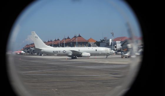 A U.S. Navy&#39;s P-8 Poseidon is parked on the tarmac at Ngurah Rai International Airport as seen from the window of Indonesian Navy&#39;s maritime patrol aircraft of 800 Air Squadron of the 2nd Air Wing of Naval Aviation Center (PUSPENERBAL), in Bali, Indonesia, Saturday, April 24, 2021. The American reconnaissance plane was expected to join the search for Indonesian navy submarine KRI Nanggala that went missing after its last reported dive Wednesday off the resort island. (AP Photo/Eric Ireng)