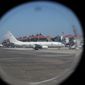 A U.S. Navy&#39;s P-8 Poseidon is parked on the tarmac at Ngurah Rai International Airport as seen from the window of Indonesian Navy&#39;s maritime patrol aircraft of 800 Air Squadron of the 2nd Air Wing of Naval Aviation Center (PUSPENERBAL), in Bali, Indonesia, Saturday, April 24, 2021. The American reconnaissance plane was expected to join the search for Indonesian navy submarine KRI Nanggala that went missing after its last reported dive Wednesday off the resort island. (AP Photo/Eric Ireng)