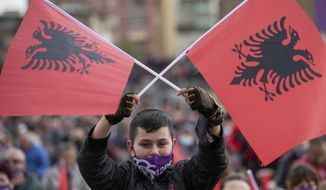 Supporter of socialist party waving Albanian flag participates in the political rally in city of Durres, Albania on Friday, April 23, 2021.Albania holds parliamentary elections on Sunday amid the virus pandemic and a bitter political rivalry between the country&#39;s two largest political parties but that will serve as a key milestone in the country&#39;s next step toward European Union membership. (AP Photo/Visar Kryeziu)