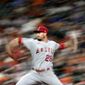 In this image taken with a slow shutter speed, Los Angeles Angels starting pitcher Andrew Heaney throws against the Houston Astros during the seventh inning of a baseball game Friday, April 23, 2021, in Houston. (AP Photo/David J. Phillip)