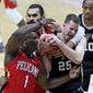 San Antonio Spurs center Jakob Poeltl (25) fights for a rebound with New Orleans Pelicans forward Zion Williamson (1) and center Steven Adams (12) during the first half of an NBA basketball game in New Orleans, Saturday, April 24, 2021. (AP Photo/Rusty Costanza)