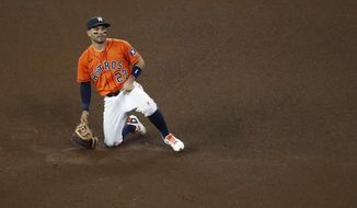 Houston Astros second baseman Jose Altuve reacts after a throwing error by shortstop Carlos Correa allowed Oakland Athletics&#39; Stephen Piscotty to reach second base in the top of the fourth inning of a baseball game Friday, April 9, 2021, in Houston. (Kevin M. Cox/The Galveston County Daily News via AP)