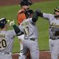 Oakland Athletics&#39; Jed Lowrie, right, celebrates his three-run home run with Elvis Andrus, center, and Mark Canha during the fourth inning of a baseball game against the Baltimore Orioles on Saturday, April 24, 2021, in Baltimore. (AP Photo/Gail Burton)