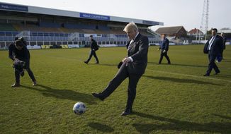 Britain&#x27;s Prime Minister Boris Johnson kicks a soccer ball during a visit to the Hartlepool United Football Club, in Hartlepool, England ahead of the May 6 by-election, Friday April 23, 2021. (Ian Forsyth/Pool via AP)