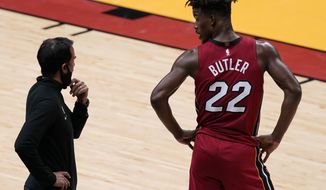 Miami Heat head coach Erik Spoelstra, left, talks to forward Jimmy Butler (22) during the first half of an NBA basketball game against the Chicago Bulls, Saturday, April 24, 2021, in Miami. (AP Photo/Marta Lavandier)