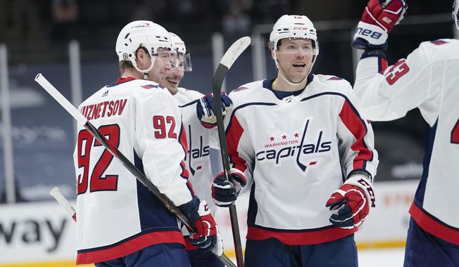 Washington Capitals&#x27; Daniel Sprong celebrates with teammates after scoring a goal during the third period of an NHL hockey game against the New York Islanders Saturday, April 24, 2021, in Uniondale, N.Y. The Capitals won 6-3. (AP Photo/Frank Franklin II)