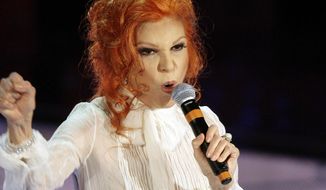 FILE - In this Feb. 27, 2007 file photo, Italian singer  Maria Ilva Biolcati, knowns as Milva, performs &amp;quot;The show must go on&amp;quot; during the Sanremo Italian song contest, in San Remo, Italy. Milva, one of Italy&#39;s most popular singers in the ‘60s and ’70s, who had many fans abroad, has died at her home in Milan at the age of 81, Italy&#39;s culture minister announced Saturday, April 24, 2021.  (AP Photo/Luca Bruno, file)