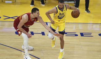 Golden State Warriors&#39; Stephen Curry, right, drives against Denver Nuggets&#39; Nikola Jokic during the first half of an NBA basketball game in San Francisco, Friday, April 23, 2021. (AP Photo/Jed Jacobsohn)