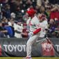 Philadelphia Phillies&#x27; Rhys Hoskins circles the bases after hitting a three-run home run off Colorado Rockies relief pitcher Jhoulys Chacin during the sixth inning of a baseball game Saturday, April 24, 2021, in Denver. (AP Photo/David Zalubowski)