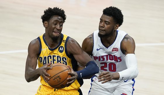 Indiana Pacers&#39; Caris LeVert (22) goes to the basket against Detroit Pistons&#39; Josh Jackson (20) during the second half of an NBA basketball game, Saturday, April 24, 2021, in Indianapolis. (AP Photo/Darron Cummings)