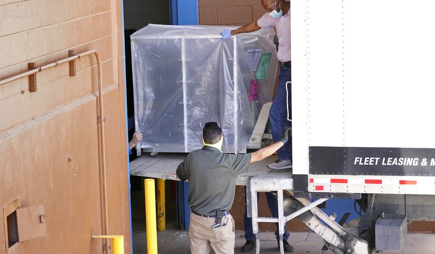 In this Wednesday, April 21, 2021 file photo, officials unload election equipment into the Veterans Memorial Coliseum at the state fairgrounds in Phoenix. Maricopa County officials began delivering equipment used in the November election won by President Joe Biden on Wednesday and will move 2.1 million ballots to the site Thursday so Republicans in the state Senate who have expressed uncertainty that Biden&#39;s victory was legitimate can recount them and audit the results. (AP Photo/Matt York) ** FILE **