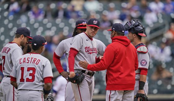 Washington Nationals starting pitcher Patrick Corbin, center, after he was pulled from the game during the fifth inning of a baseball game against the New York Mets at Citi Field, Sunday, April 25, 2021, in New York. (AP Photo/Seth Wenig)