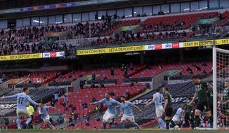 Manchester City&#x27;s Aymeric Laporte, center, celebrates after scoring the opening goal during the English League Cup final soccer match between Manchester City and Tottenham Hotspur at Wembley stadium in London, Sunday, April 25, 2021. (AP Photo/Alastair Grant)