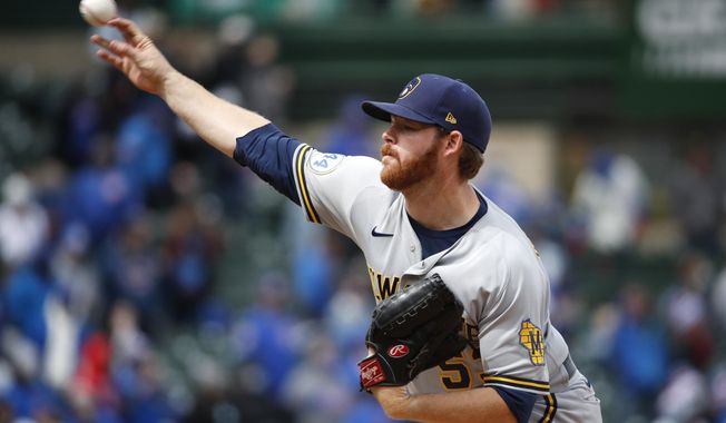 Milwaukee Brewers starting pitcher Brandon Woodruff delivers during the fourth inning of a baseball game against the Chicago Cubs in Chicago, on Sunday, April 25, 2021. (AP Photo/Jeff Haynes)