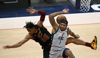 Cleveland Cavaliers forward Isaac Okoro (35) and Washington Wizards guard Bradley Beal (3) collide during the second half of an NBA basketball game, Sunday, April 25, 2021, in Washington. Beal was called for a foul on the play. (AP Photo/Nick Wass)