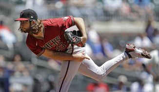 Arizona Diamondbacks pitcher Zac Gallen works against the Atlanta Braves in the first inning of the first baseball game of a double header, Sunday, April 25, 2021, in Atlanta. (AP Photo/Ben Margot)