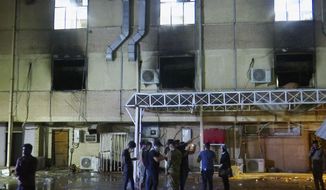 In this image made from video, first responders work the scene of a fire at a hospital in Baghdad on Saturday, April 24, 2021. The fire broke out in the Baghdad hospital that cares for coronavirus patients after oxygen cylinders reportedly exploded late Saturday, officials said. (AP Photo)