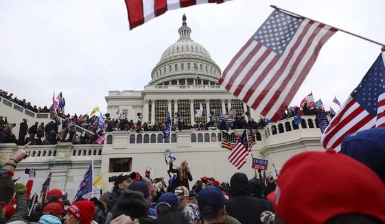 Supporters of President Donald Trump gather outside the U.S. Capitol, Wednesday, Jan. 6, 2021, in Washington. (AP Photo/Shafkat Anowar)