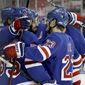New York Rangers&#39; Mika Zibanejad (93) is surrounded by teammates after he scored a hat trick in the second period against the Buffalo Sabres during an NHL hockey game Sunday, April 25, 2021, in New York. (Elsa/Pool Photo via AP)