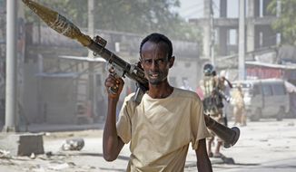 A soldier supporting anti-government opposition groups carries a rocket-propelled grenade launcher on a street in the Fagah area of Mogadishu, Somalia Sunday, April 25, 2021. Gunfire was exchanged Sunday between government forces loyal to President Mohamed Abdullahi Mohamed, who signed into law on April 14 a two year extension of his mandate and that of his government, and other sections of the military opposed to the move and sympathetic to former presidents Hassan Sheikh Mohamud and Sharif Sheikh Ahmed. (AP Photo/Farah Abdi Warsameh)