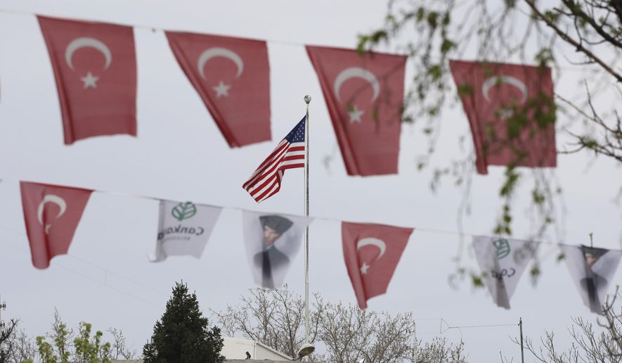 Turkish flags and banners depicting Mustafa Kemal Ataturk, the founder of modern Turkey, decorate a street outside the United States embassy in Ankara, Turkey, Sunday, April 25, 2021. Turkey&#39;s foreign ministry has summoned the U.S. Ambassador in Ankara to protest the U.S. decision to mark the deportation and killing of Armenians during the Ottoman Empire as &amp;quot;genocide.&amp;quot; On Saturday, U.S. President Joe Biden followed through on a campaign promise to recognize the events that began in 1915 and killed an estimated 1.5 million Ottoman Armenians as genocide. (AP Photo/Burhan Ozbilici)